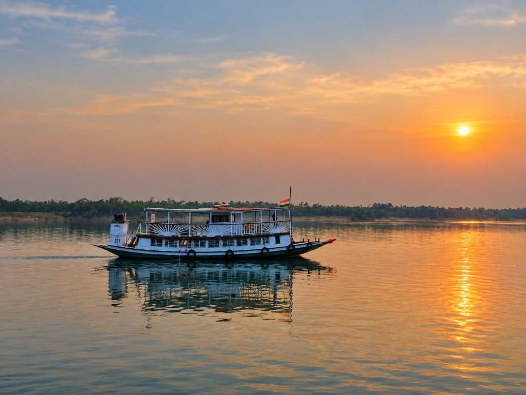 Mangrove Forest Camp private safari boat on a Sundarban river at sunset