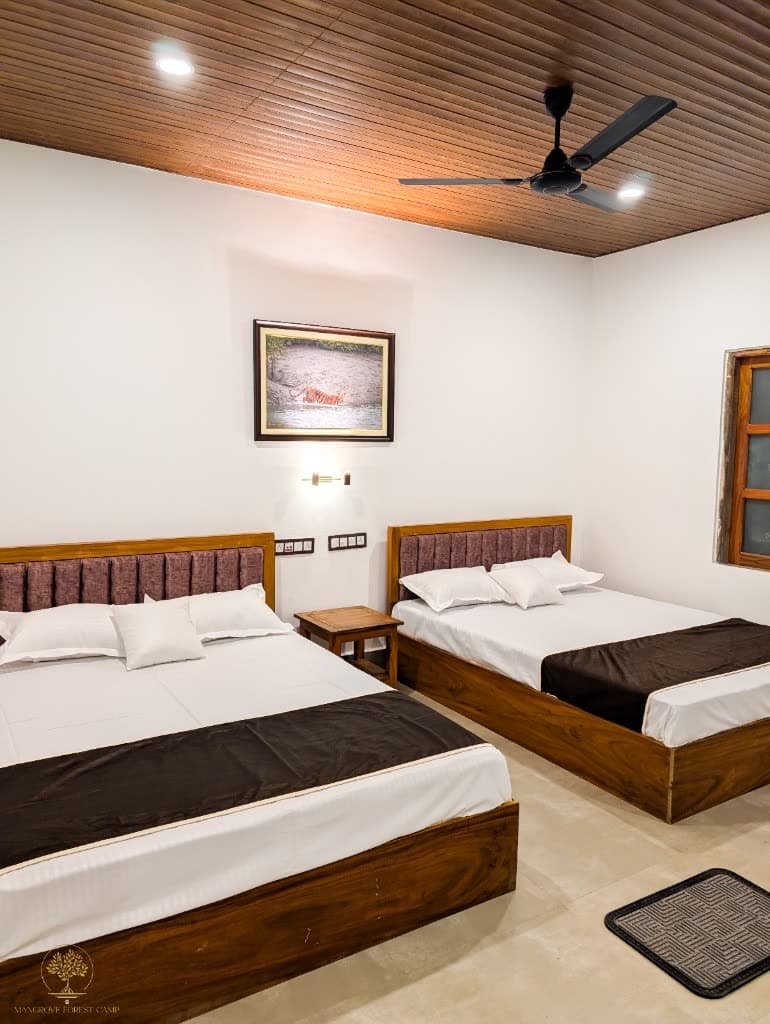 Twin bedroom at Mangrove Forest Camp with tiger artwork and forest-green walls