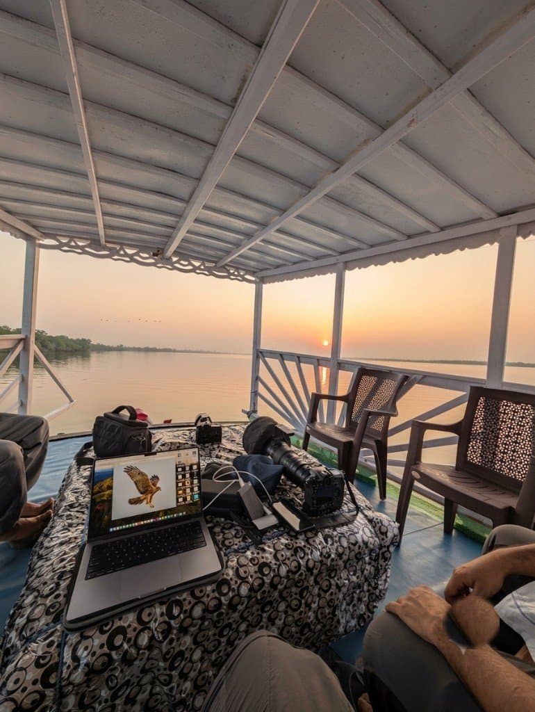 Wildlife photography setup on a Mangrove Forest Camp Sundarban safari boat at sunset